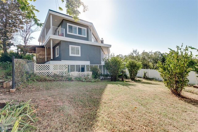 5100 Burr Oaks Rd, Oklahoma City, OK 73105 - back of house featuring a yard, a balcony, stucco siding, and fence