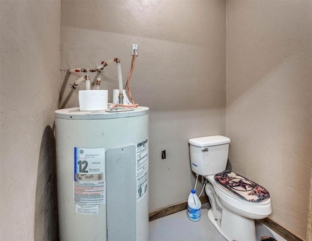 bathroom featuring electric water heater and toilet