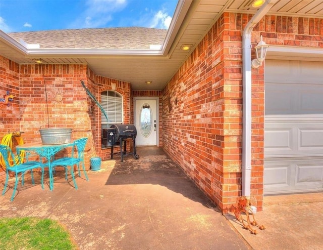 view of patio / terrace featuring area for grilling and a garage