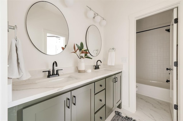 full bathroom with tiled shower / bath combo, vanity, and toilet