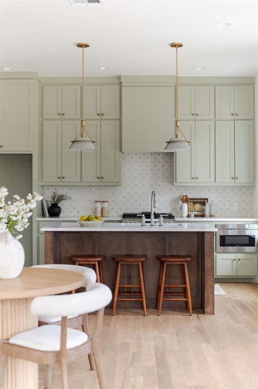 kitchen featuring sink, pendant lighting, and decorative backsplash