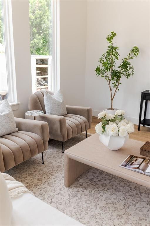 living area with light wood-style flooring and baseboards