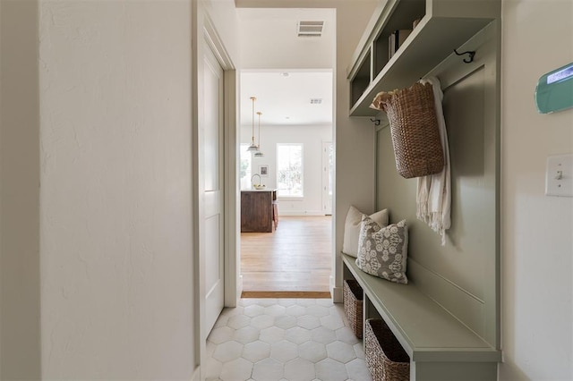 mudroom with light tile patterned floors and visible vents