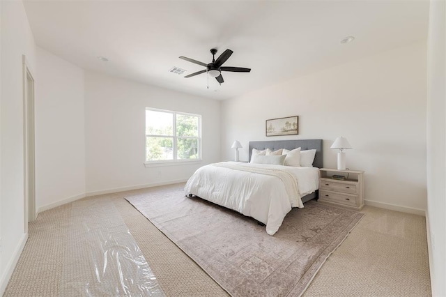 bedroom with light carpet, visible vents, ceiling fan, and baseboards