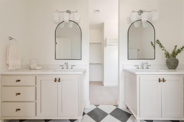 full bath featuring a sink, visible vents, two vanities, and tile patterned floors