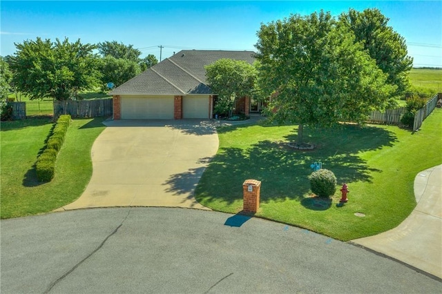 view of front of home with a front lawn and a garage