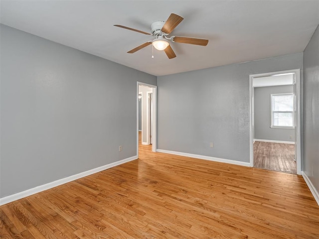 empty room with ceiling fan and light hardwood / wood-style floors