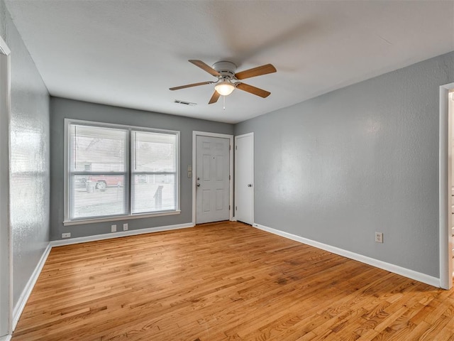 spare room featuring light wood-type flooring and ceiling fan