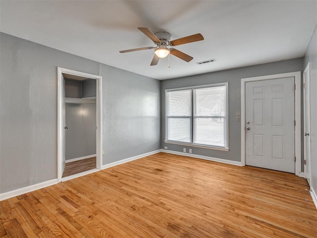 unfurnished bedroom with ceiling fan and light hardwood / wood-style floors