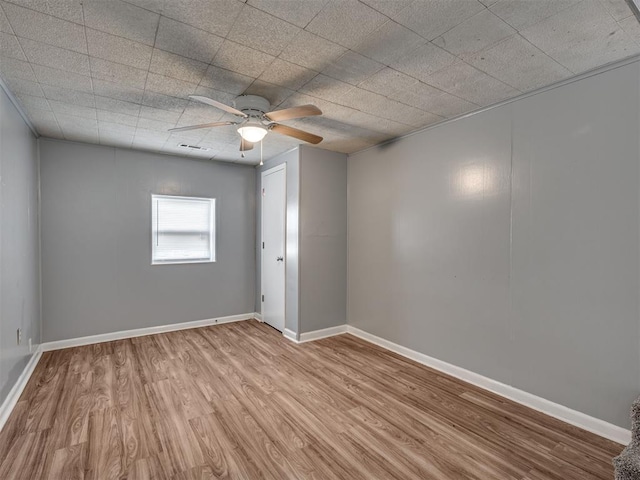 spare room with light hardwood / wood-style floors and ceiling fan