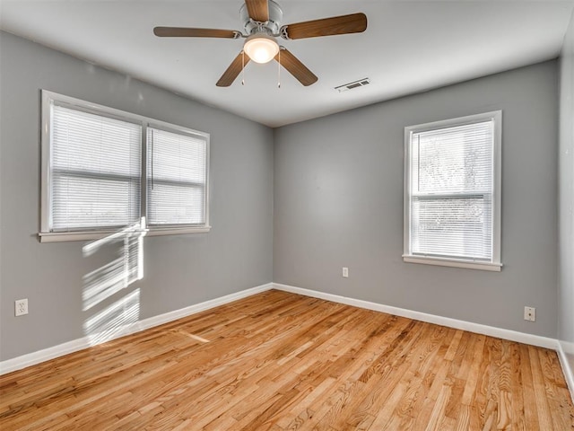 unfurnished room with light wood-type flooring and ceiling fan