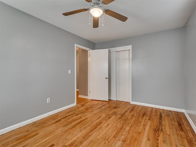 unfurnished bedroom with ceiling fan, a closet, and light wood-type flooring