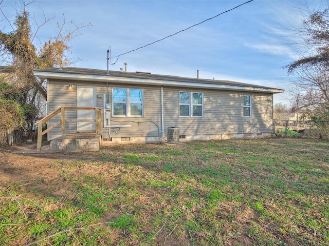 rear view of property featuring a yard and central AC unit