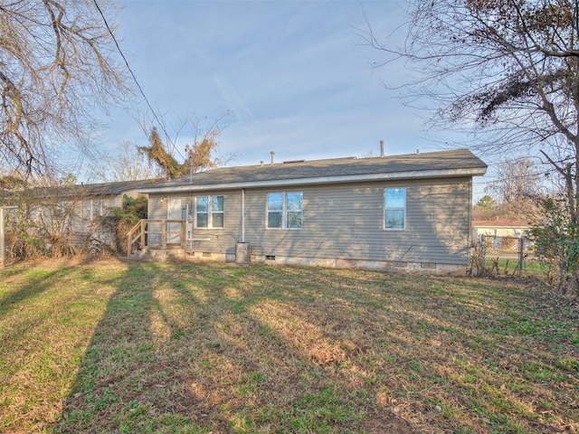 rear view of house featuring a lawn