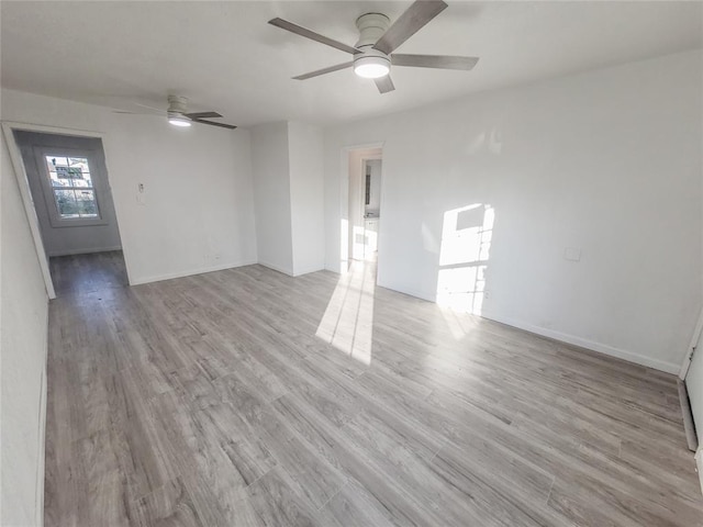 unfurnished room with ceiling fan and light wood-type flooring