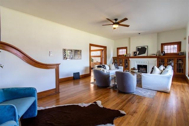 living room featuring hardwood / wood-style floors and ceiling fan