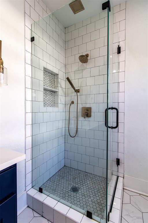 bathroom featuring an enclosed shower and vanity