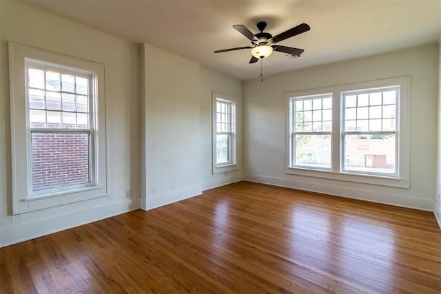 unfurnished room with ceiling fan and hardwood / wood-style floors