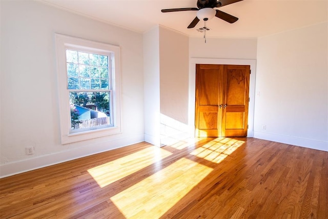 spare room with crown molding, ceiling fan, and light hardwood / wood-style flooring