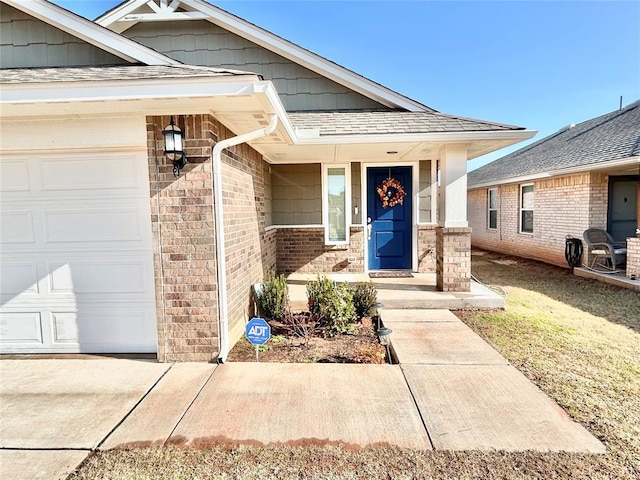 doorway to property with a garage