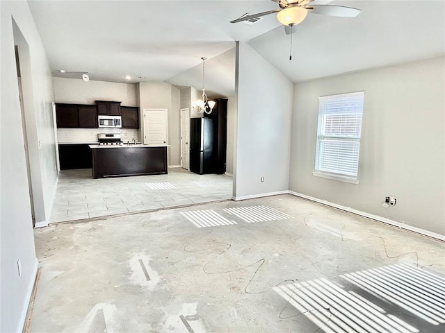 kitchen featuring backsplash, vaulted ceiling, a kitchen island, ceiling fan with notable chandelier, and appliances with stainless steel finishes