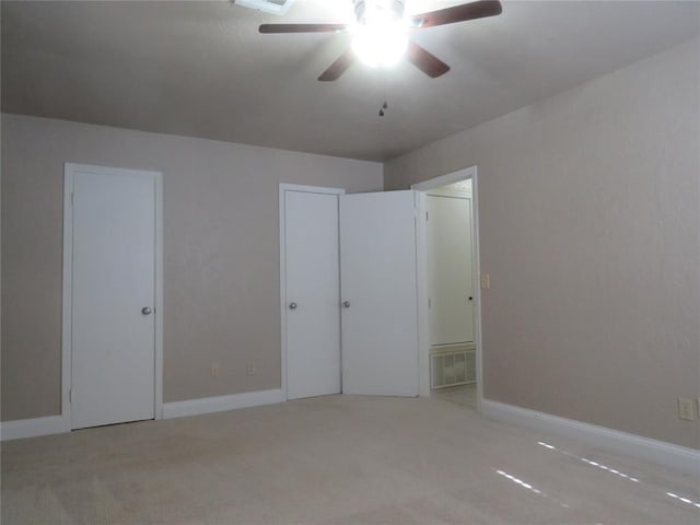 unfurnished bedroom featuring light carpet and ceiling fan