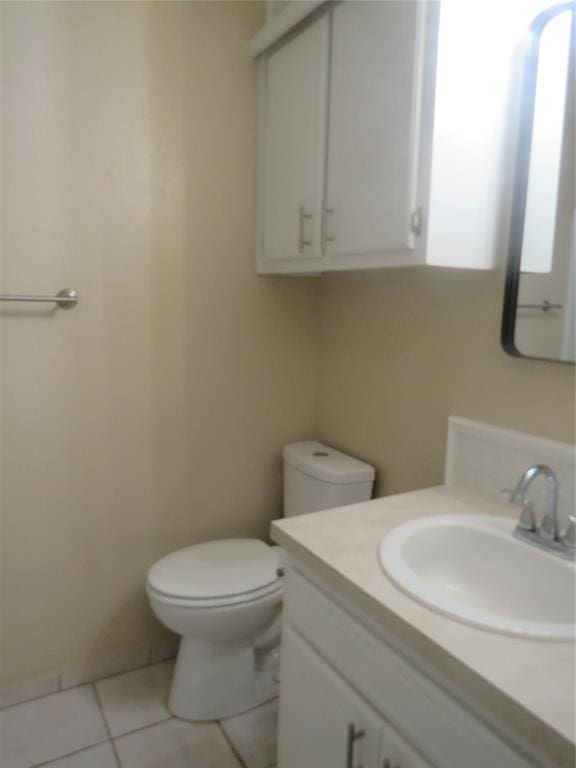 bathroom featuring tile patterned floors, vanity, and toilet