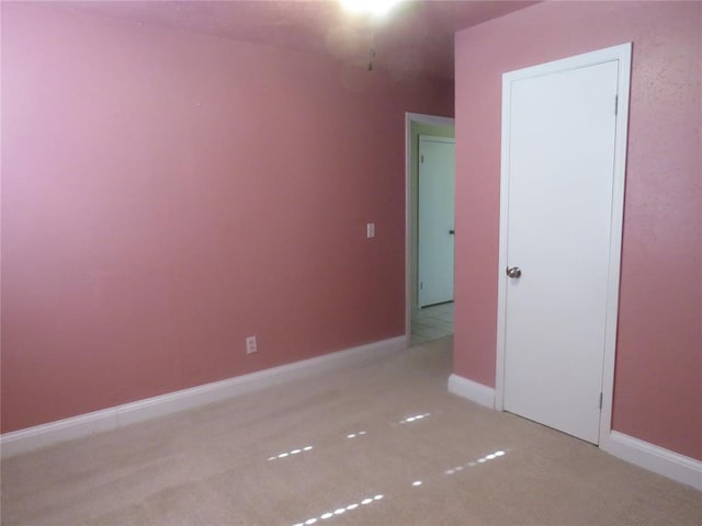 unfurnished bedroom with light colored carpet