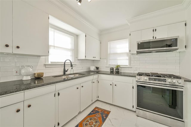 kitchen featuring backsplash, stainless steel appliances, white cabinetry, and sink