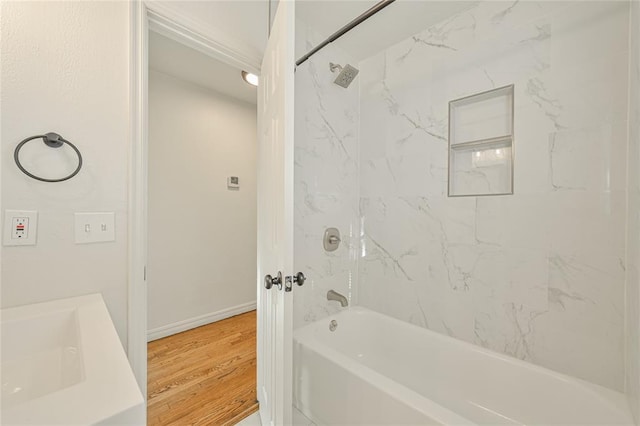 bathroom with vanity, wood-type flooring, and tiled shower / bath