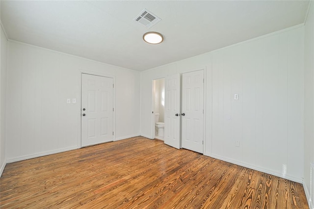 spare room with wood-type flooring