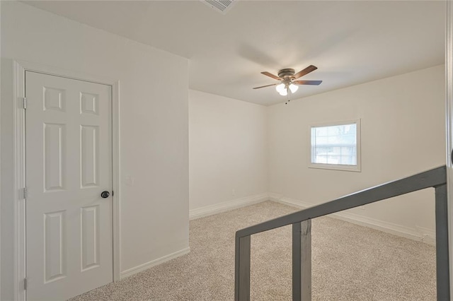 unfurnished room featuring light colored carpet and ceiling fan