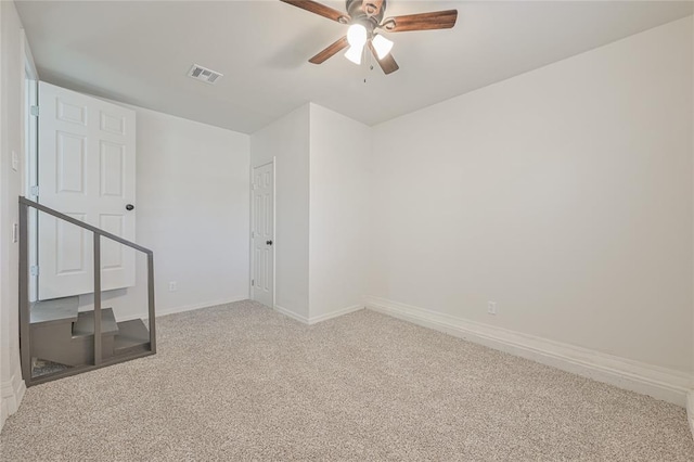 carpeted spare room featuring ceiling fan