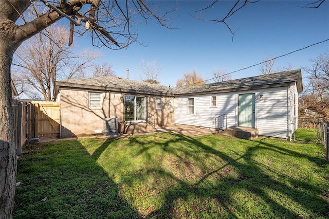 back of house featuring a yard