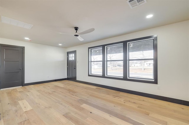 spare room featuring light hardwood / wood-style flooring and ceiling fan