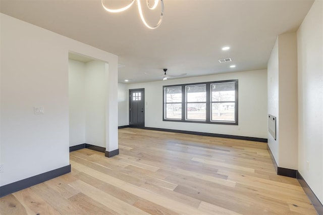 unfurnished room featuring ceiling fan and light wood-type flooring