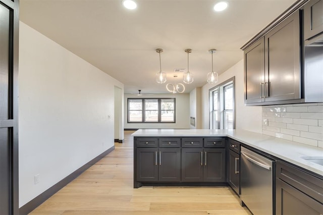 kitchen featuring dishwasher, hanging light fixtures, backsplash, kitchen peninsula, and light wood-type flooring