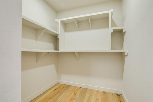 spacious closet featuring hardwood / wood-style floors