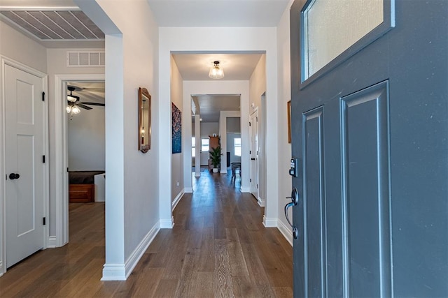 entryway with ceiling fan and dark wood-type flooring