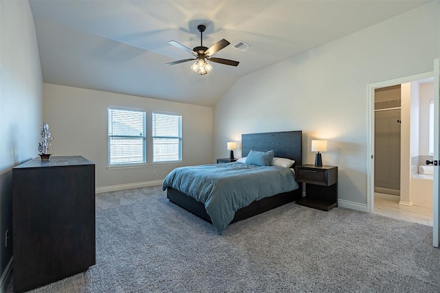 bedroom featuring light carpet, connected bathroom, ceiling fan, and lofted ceiling