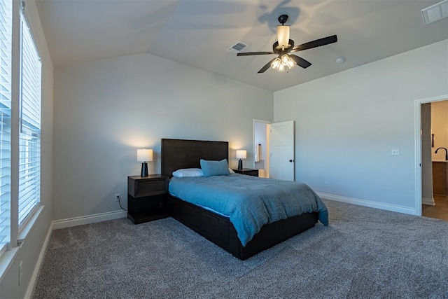 carpeted bedroom with multiple windows, ceiling fan, and lofted ceiling