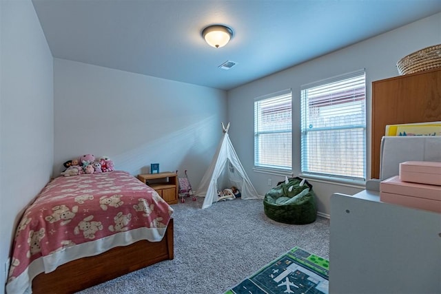 bedroom with carpet flooring and multiple windows