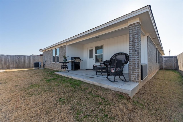 back of house featuring a yard, cooling unit, and a patio