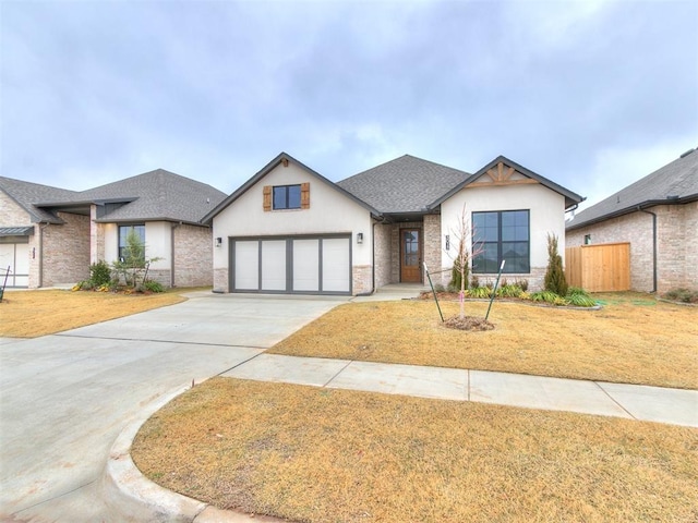 view of front facade with a garage and a front lawn