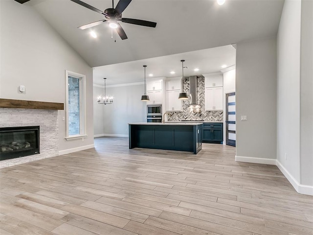 kitchen featuring decorative backsplash, white cabinetry, hanging light fixtures, and blue cabinets