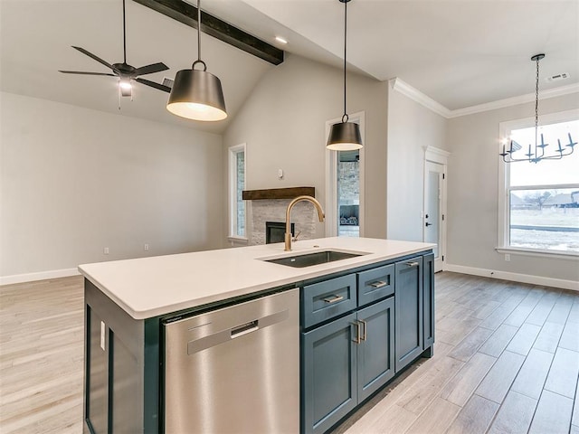 kitchen with dishwasher, a center island with sink, ceiling fan with notable chandelier, sink, and decorative light fixtures