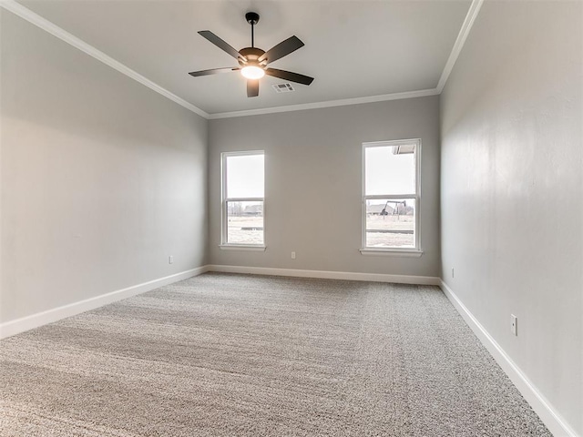 unfurnished room featuring carpet flooring, a wealth of natural light, ceiling fan, and ornamental molding