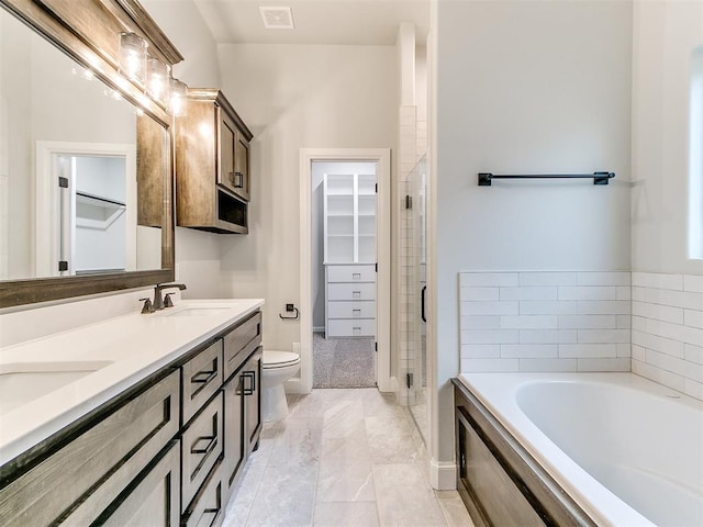 full bathroom featuring vanity, toilet, and independent shower and bath