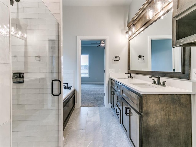 bathroom featuring vanity, ceiling fan, and independent shower and bath