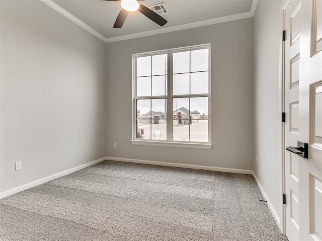 carpeted empty room with ceiling fan and crown molding